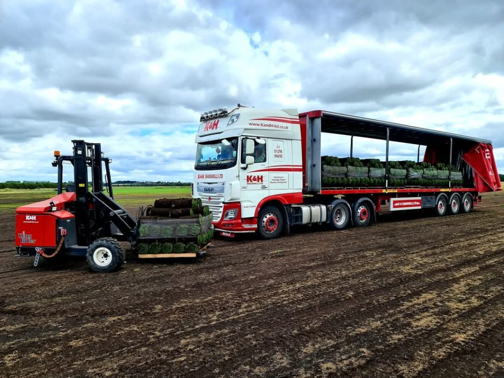 white K&H (Bakewell) Limited DAF truck pulling curtainside trailer