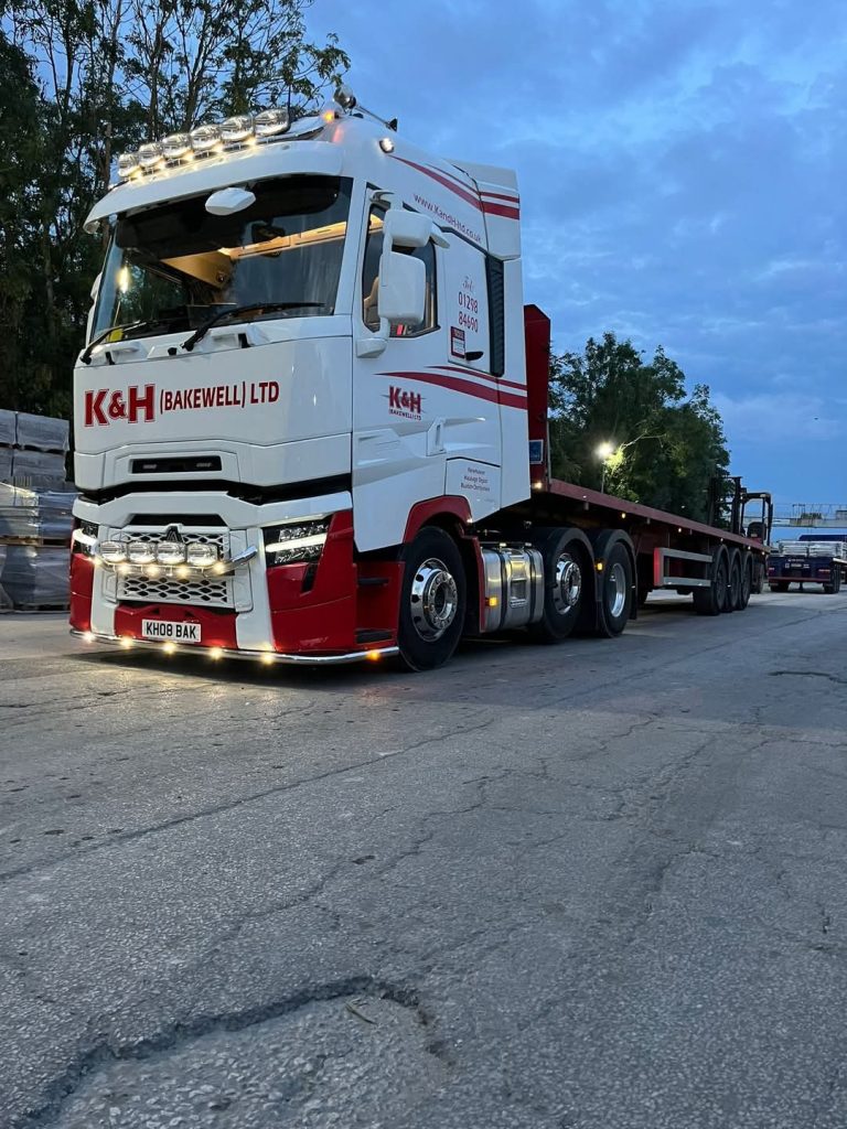 white K&H (Bakewell) Limited Renault pulling flatbed trailer
